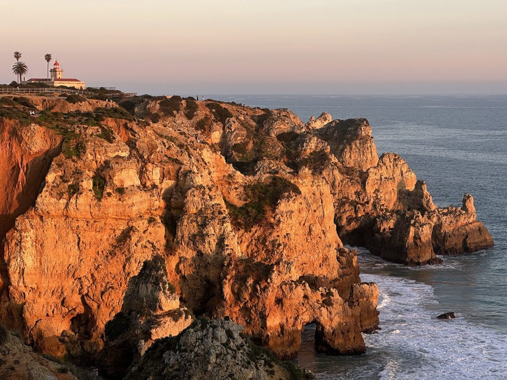 Scenic coastal cliffs of the Ponta da Piedade and lighthouse at sunset, Lagos, Faro, Portugal, February 2025