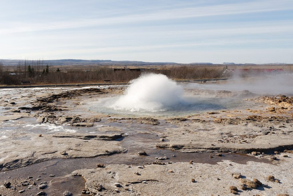 Strokkur geyser erupting in the geothermal landscape of Iceland